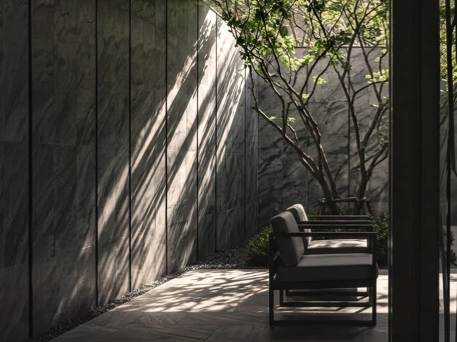 Aetas Taman Desa shaded courtyard with lounge chairs and trees