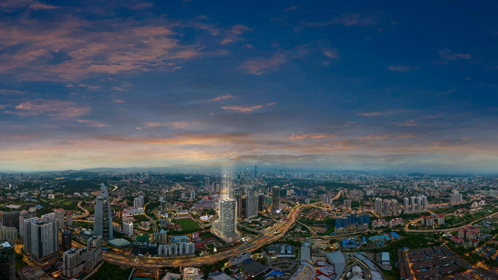 Aerial view of Bangsar at dusk, with the Kuala Lumpur skyline beyond