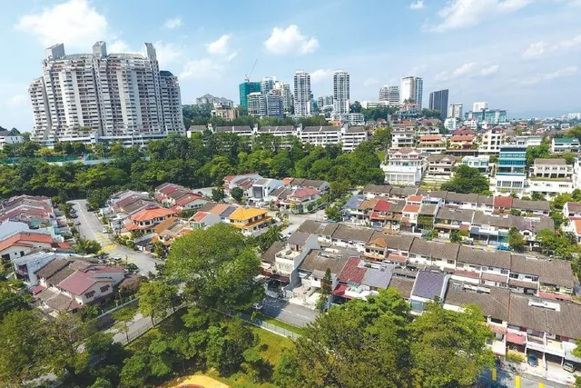 Landed homes and trees in Bangsar, with towers beyond
