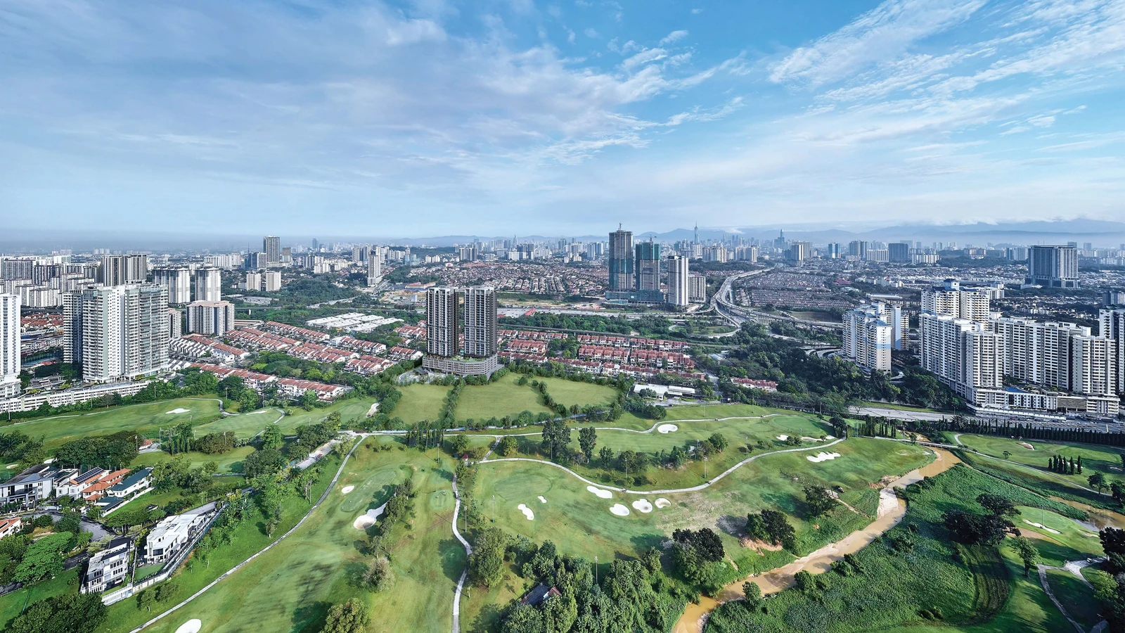 Bukit Jalil Golf & Country Resort from above, with Bukit Jalil and the Kuala Lumpur skyline behind