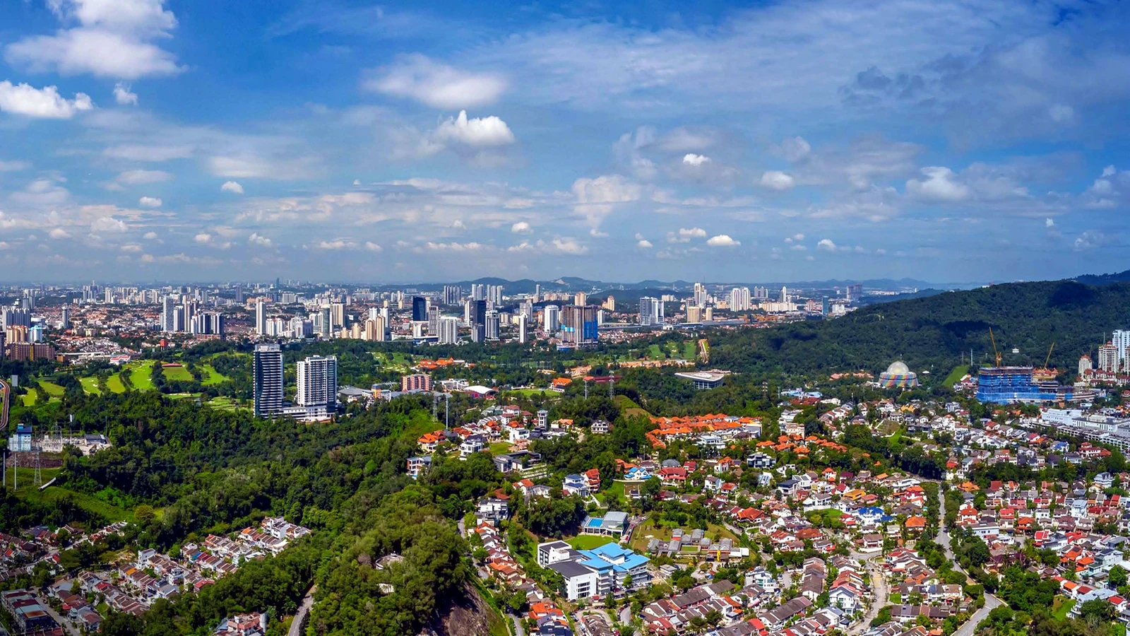 Aerial view over Bukit Kiara and Damansara Heights towards the Kuala Lumpur skyline