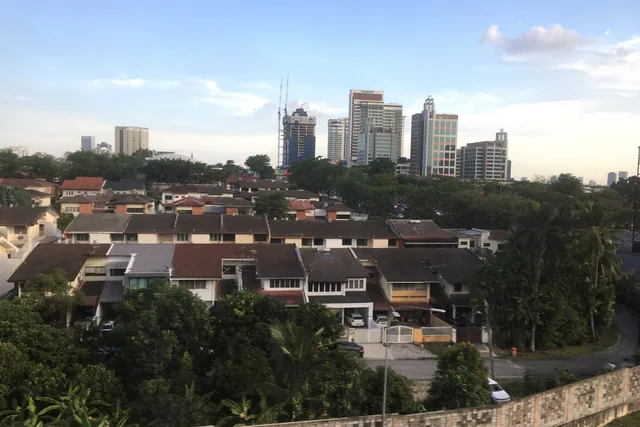 Landed homes among the trees in Damansara Kim, Petaling Jaya, with the city skyline beyond