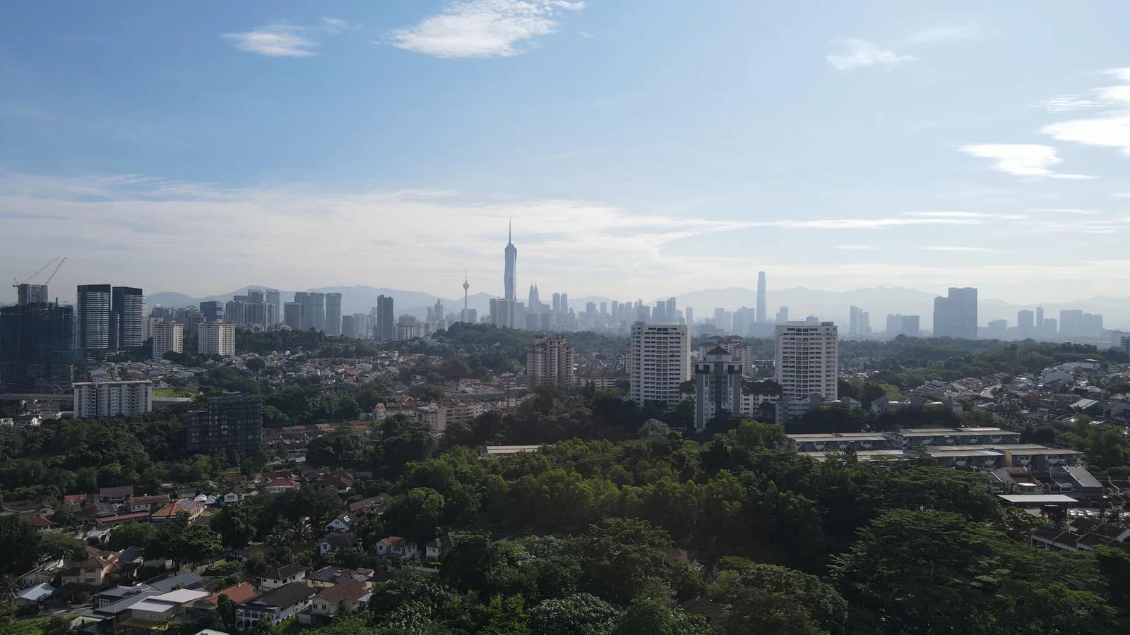 View from Taman Desa over mature trees to the Kuala Lumpur skyline