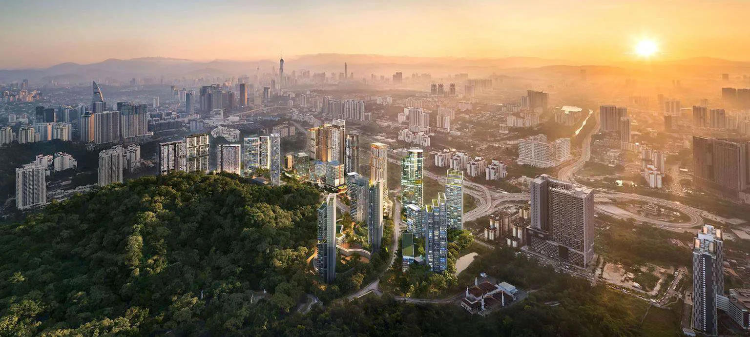 Aerial view of Pantai Sentral Park beside the Bukit Kerinchi Forest Reserve, with the Kuala Lumpur skyline at sunset
