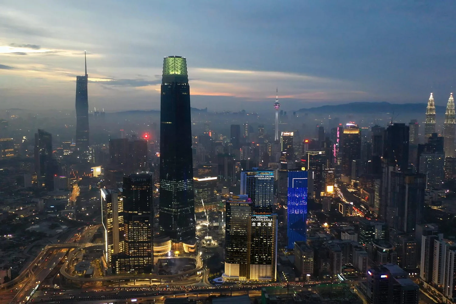 Golden Crown Residence in the TRX skyline at dusk, beside The Exchange 106