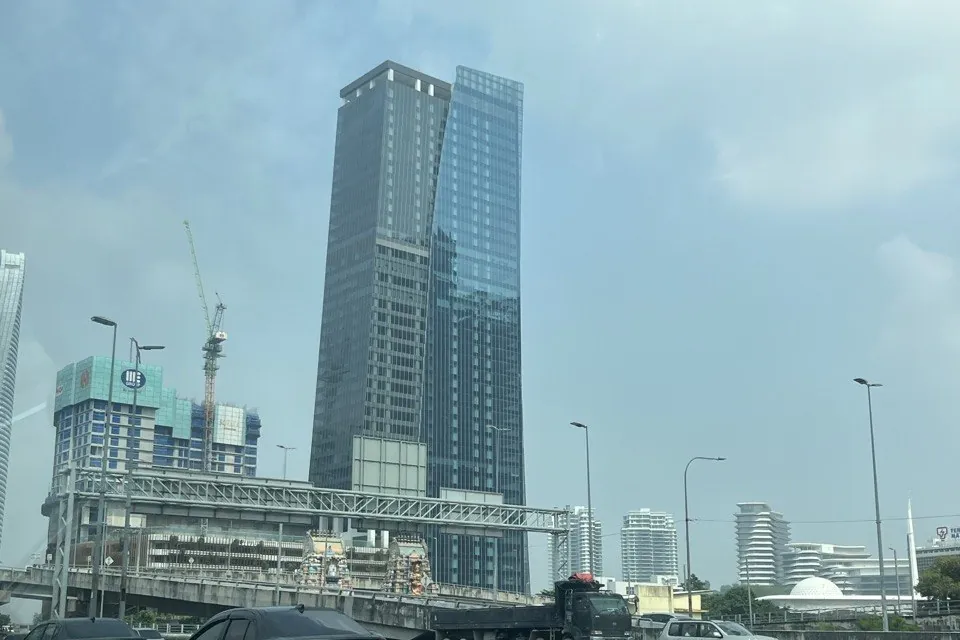 The Khaya Residences site on Jalan Bangsar in September 2026, with the office tower and a crane beside it
