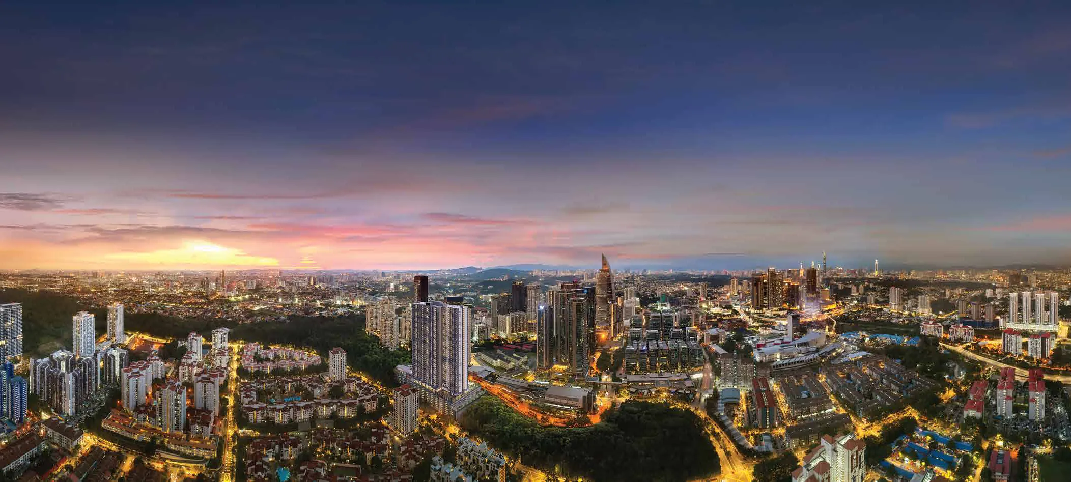 Aerial view of Bangsar South at dusk, with the Kuala Lumpur skyline beyond