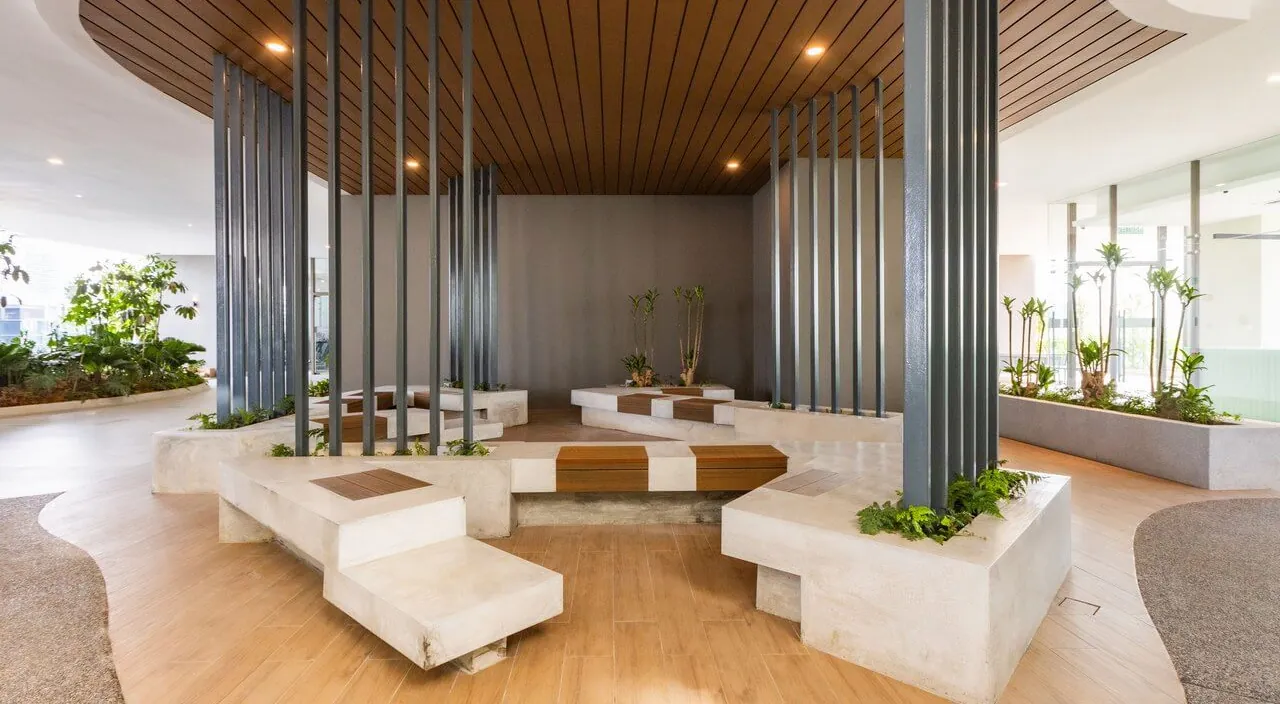 The community hangout pavilion at Laurel Residence, with benches under a timber ceiling