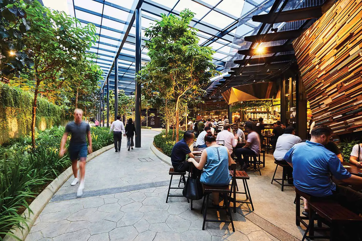 Restaurants along a tree-lined walkway at Nexus, Bangsar South