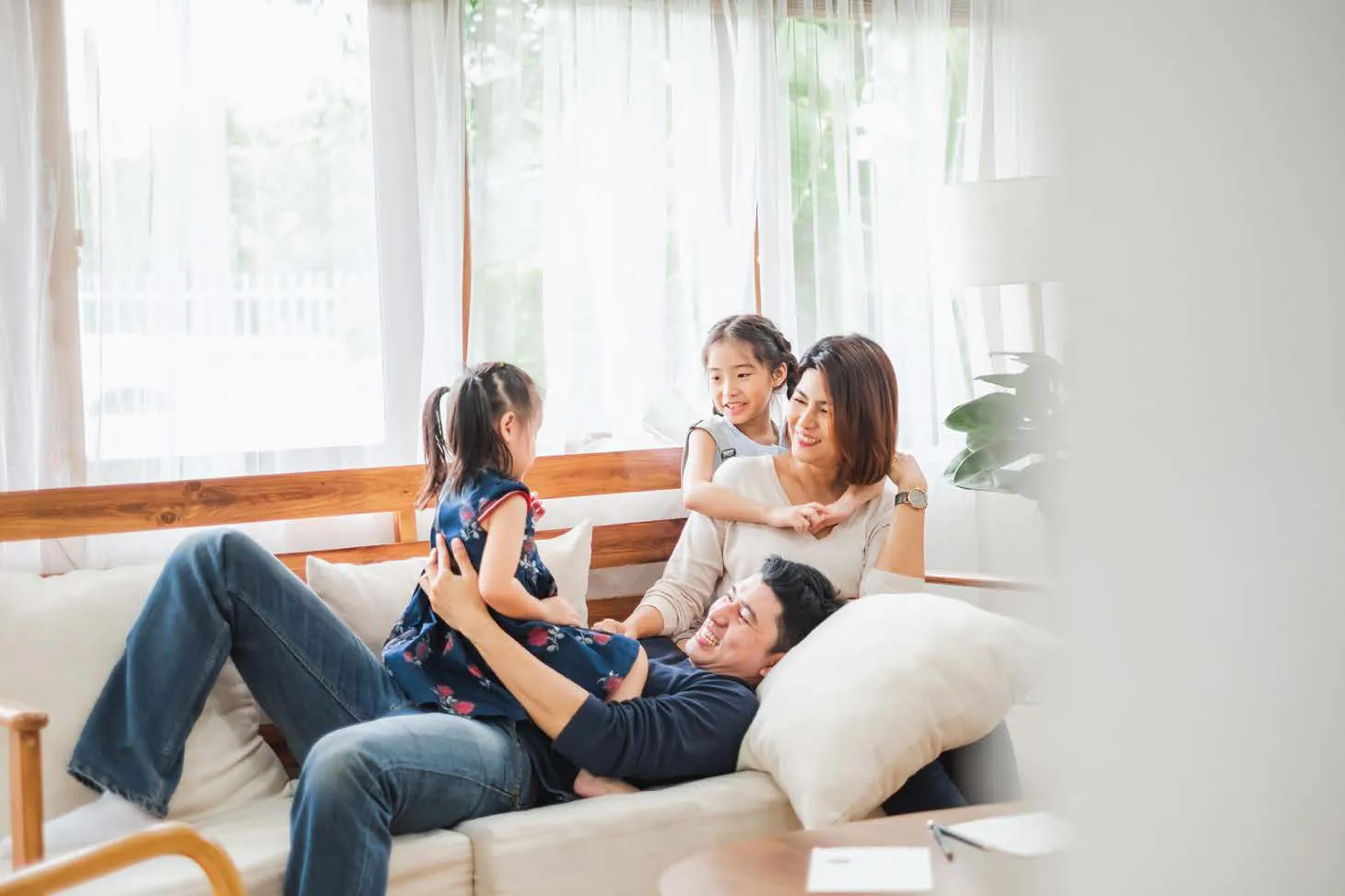 A family relaxing together on the sofa at home