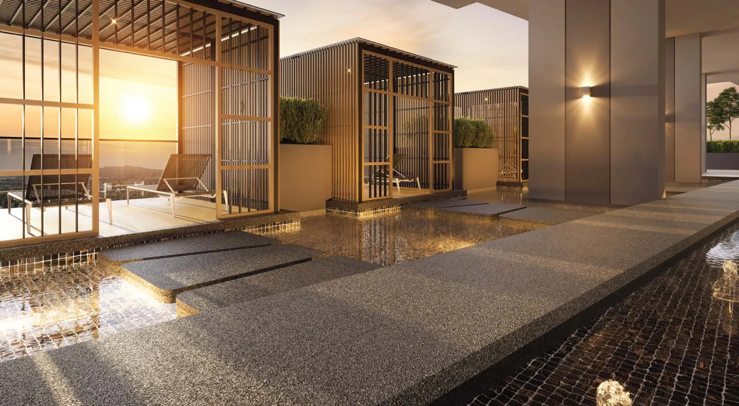 A viewing gazebo over a water feature at OAKA Residences at sunset