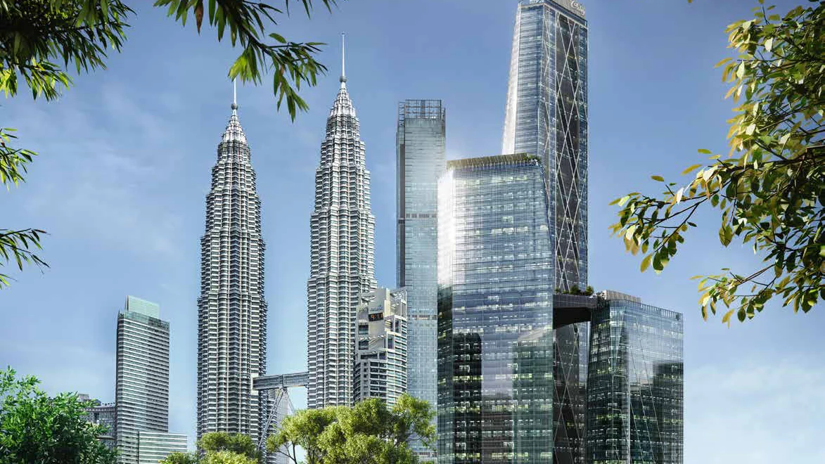 Oxley Towers beside the Petronas Twin Towers, seen through the trees of KLCC Park