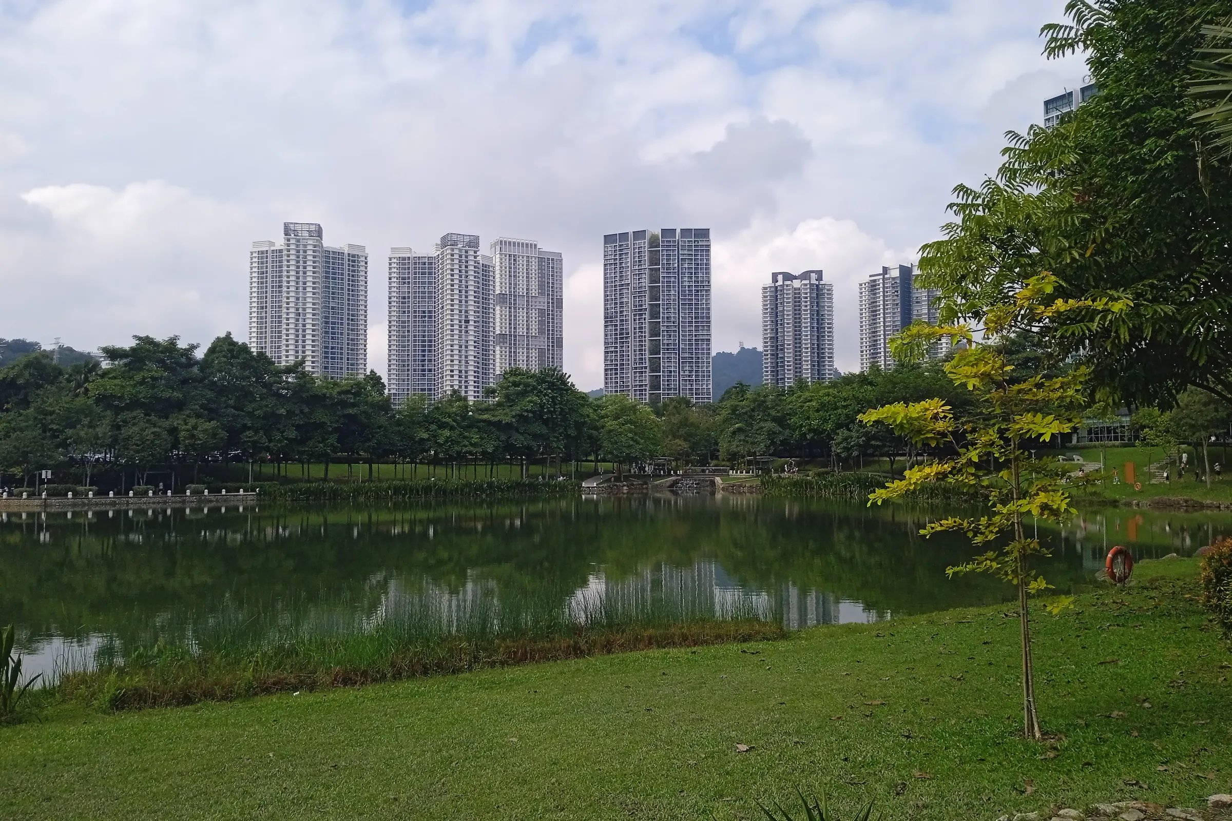 The lake and lawns of Central Park at Desa ParkCity, Kuala Lumpur, with the township's residential towers behind