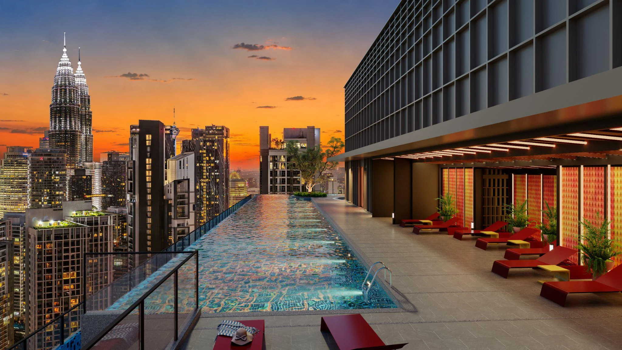 The Level 52 Sky Pool at Phoeniz Suites at sunset, facing the Petronas Twin Towers