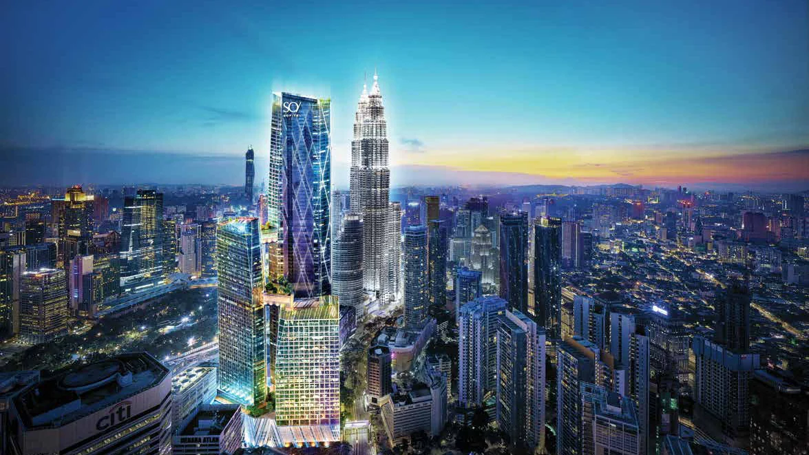 The SO/ Kuala Lumpur tower at dusk, beside the Petronas Twin Towers