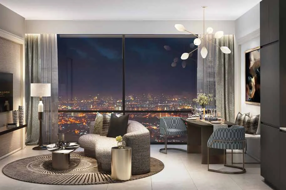 A living and dining room at SO/ Kuala Lumpur Residences with a night view of the city