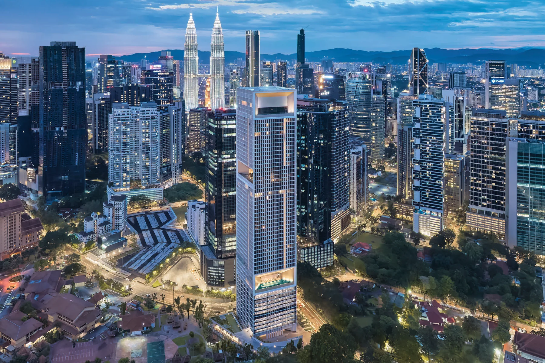 Aerial view of The Conlay in KL City Centre at dusk, with the Petronas Twin Towers